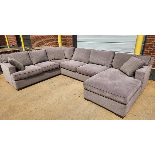 A three-piece Arhaus Camden sectional in the “Marble” gray color, offering broad proportions and a clean contemporary...