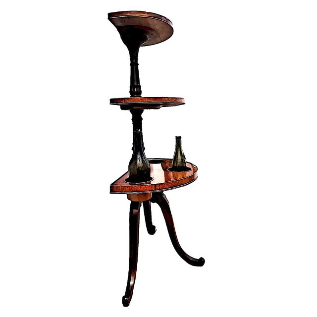 This 19th-century mahogany, three-tier demilune wine butler, also called a “dumbwaiter,” was historically used for self-...