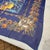 This is an exquisite silk scarf from Lalique, featuring a rich, deep blue background. The design is highly ornate and...