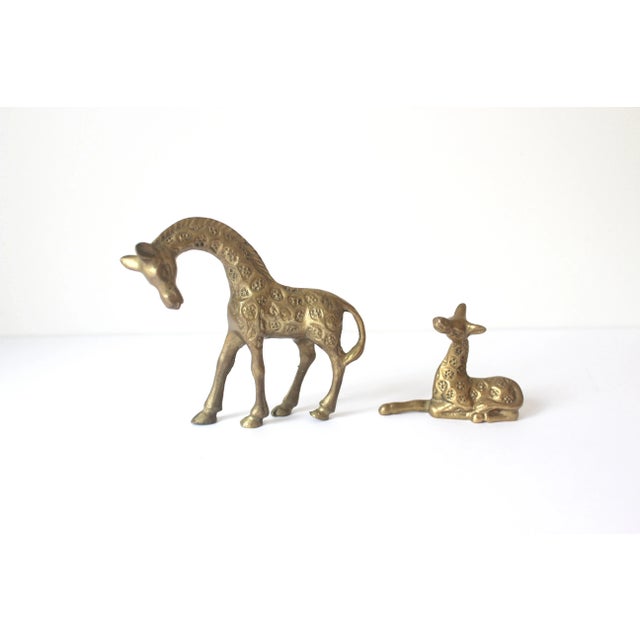 These little guys are really cute. It is a small vintage brass baby giraffe and mom. Perfect for tucking into you shelf...