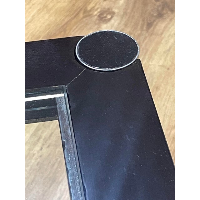 1970s coffee table with a modern metal frame and glass shelves. The supporting structure is made of chromed steel with...