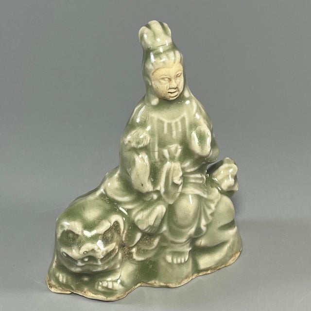 Classic Chinese celadon‑glazed ceramic seated figurine with fine moulded details. Elegant celadon glaze, nicely shaped...