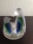 It is Satin Glass Penguins Candle Holder. Multicolor & satin glass gives it beauty. Great decor piece. Procured at antique...