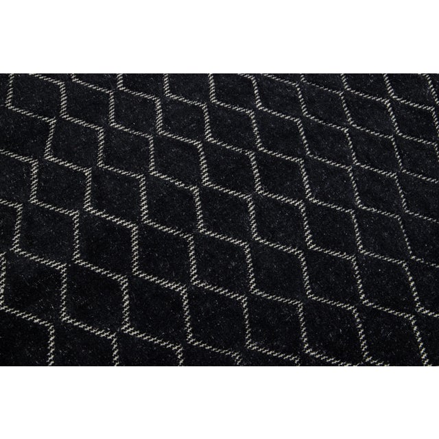 Introducing a contemporary Moroccan rug with a lavish allover geometric design intricately hand-knotted against a backdrop...