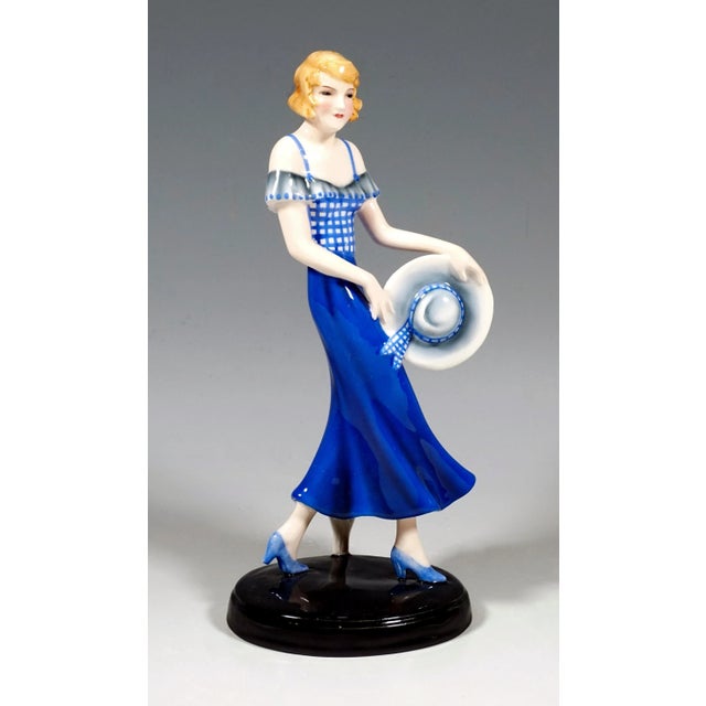 Very rare goldscheider vienna ceramic figurine of the 1930s: the striding blonde girl in the blue pinafore dress holds her...