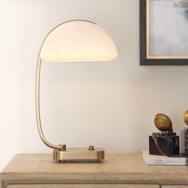 Showcasing A Captivating Minimalist Design, This Desk Lamp Features A Gracefully Curved Antique Brass Plated Frame That...