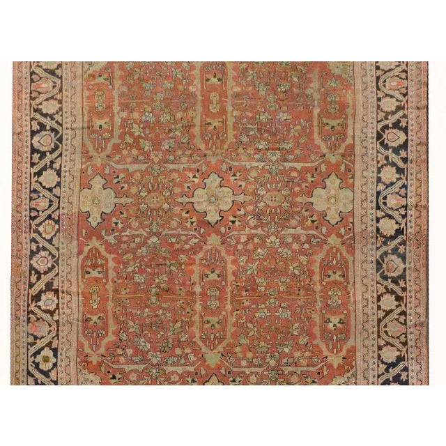 An outstanding early 20th century Persian palatial-scale Sultanabad rug with an exquisite all-over scrolling vine and...