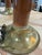 Elegant pair of mid-century modern table lamps featuring warm brass construction accented with rich brown lacquered...