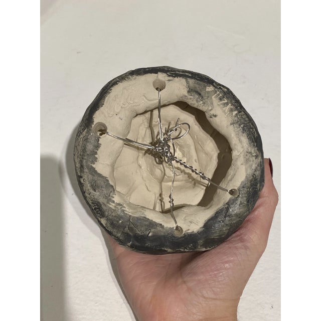 Amorphous gray painted ceramic sculpture with textured hatching by artist Eileen Braun.