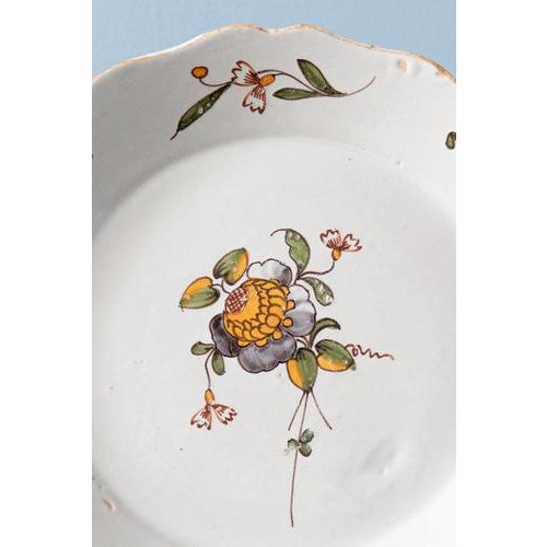 Diameter: 23 cm Height: 3 cm A chip and some glaze losses to edge.