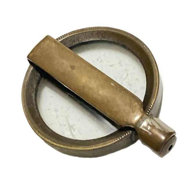 The brass handle folds up and over the circular lens, making it a portable or pocket-sized tool. Marked "Depose" on...