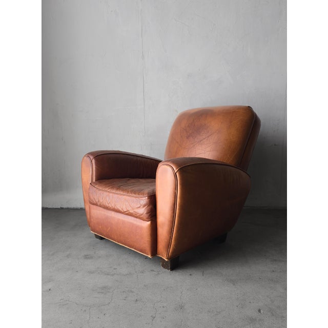 Beautiful vintage leather club chair inspired by classic European design. The chair is oversized, featuring a reclining...
