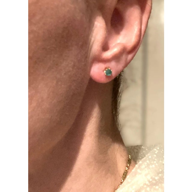 This is part of Chairish’s Fine Jewelry assortment. A pair of Emerald gemstone and 14 karat yellow gold stud earrings,...