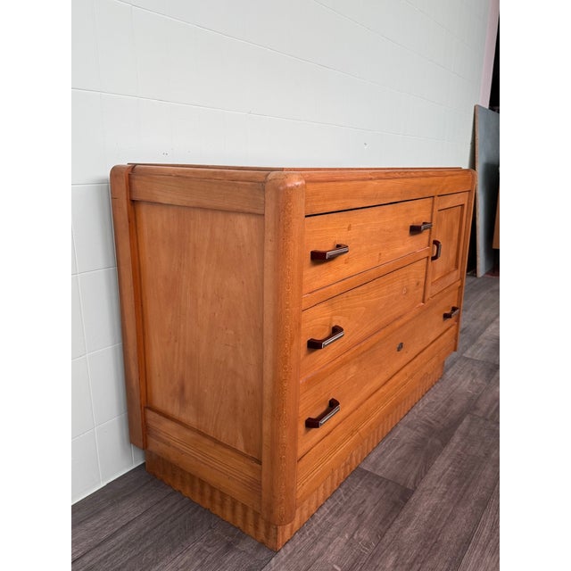 This piece of furniture is an example of an Art Deco sideboard or chest of drawers, dating approximately to the 1930s or...