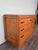 This piece of furniture is an example of an Art Deco sideboard or chest of drawers, dating approximately to the 1930s or...