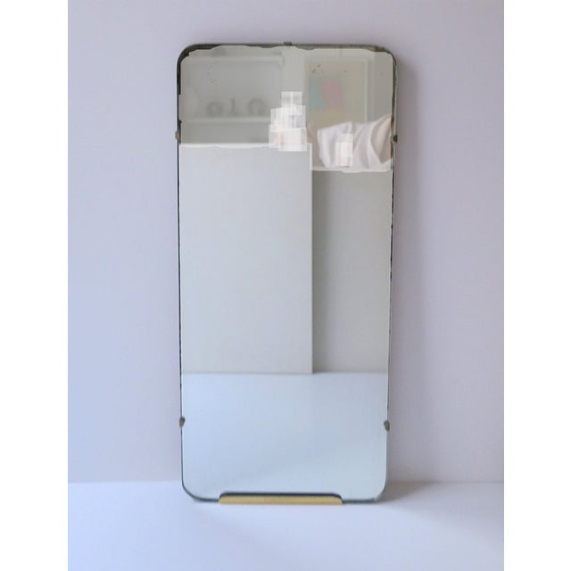 A rectangular wall mirror, Art Deco Modern period, circa early to early mid-20th century. Mirror is 'relatively' slender...