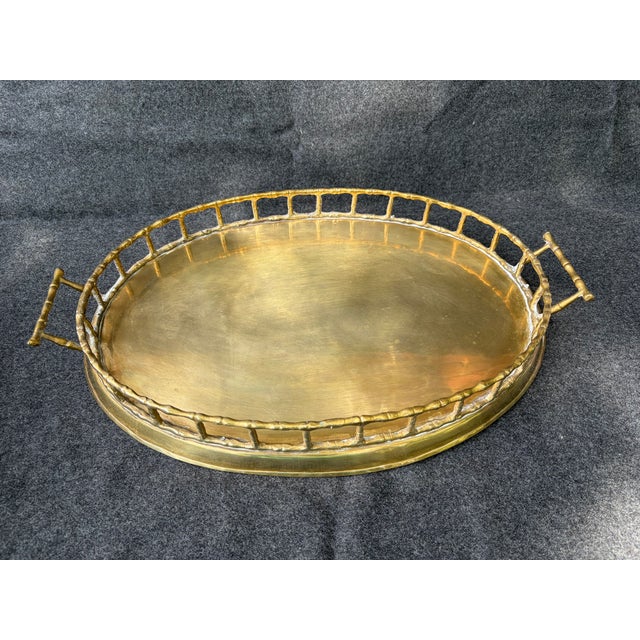 Vintage polished, oval, open faux bamboo brass serving tray with side handles. Solid base with a pretty open edge and...