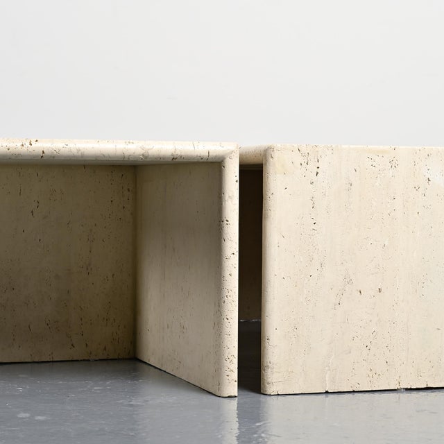 Set of four travertine drop tables forming a coffee table, made in Italy in the 1970s. Each piece features an L-shaped...