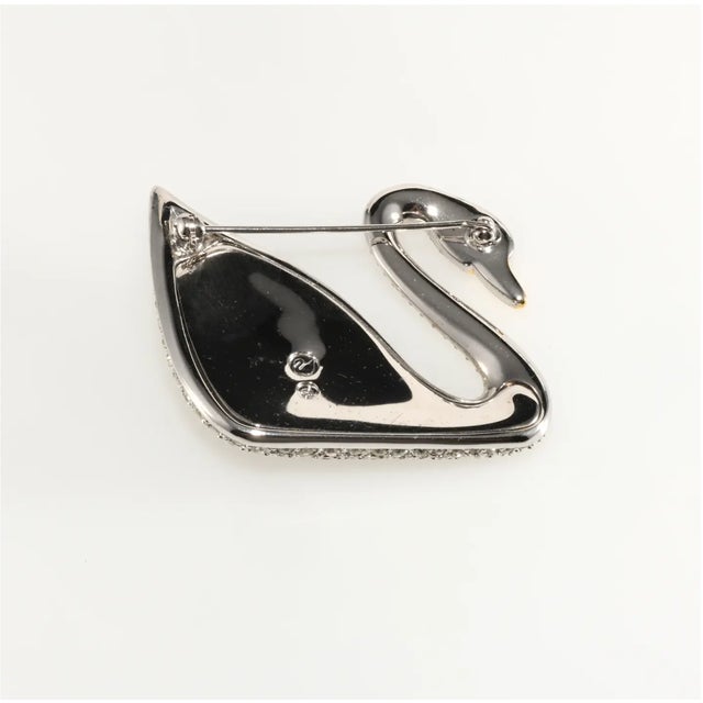 Swarovski swan brooch shaped like the company's famous logo encrusted with pave' set clear rhinestones. It is beautifully...