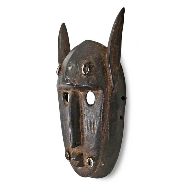 Original vintage carved wood Dogon tribal mask from Mali. Round eye holes, elongated thin nose, pointed zoomorphic ears,...