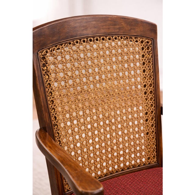 This refined set of five antique oak armchairs features beautifully preserved woven wicker backs, warm oak frames, and...