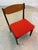A timeless classic of Danish mid-century design: This upholstered chair by Erik Buch, crafted from solid teak, combines...