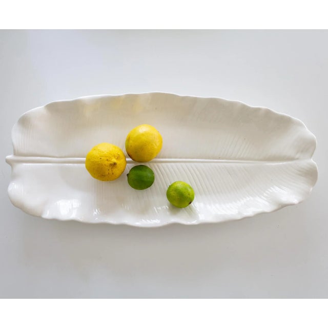 This oversized white ceramic banana leaf serving platter is from the Metlox collection Lotus White, which was in...