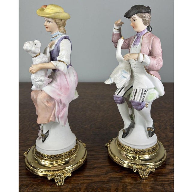 Each figurine is delicately crafted in porcelain with expressive facial features, period clothing, and gentle pastel...
