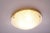 This flush mount was manufactured by Fischer Leuchten in Germany. The light has a brass finish and a textured glass shade....