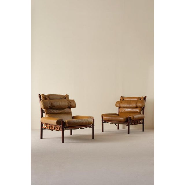 A pair of the very comfortable Inca chair in patinated brown original buffalo leather. Designed by Arne Norell, produced...