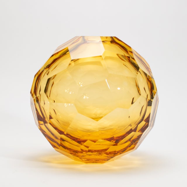 A radiant study in light and form, this hand-blown Murano globe vase in amber exudes warmth, brilliance, and artisanal...