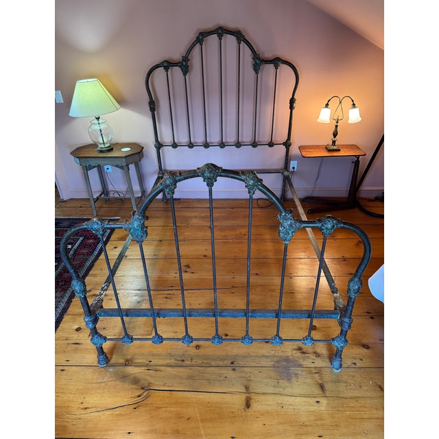Rare! Beautiful late-19th-century Victorian iron bed frame with an ornate, highly detailed design. The frame features...
