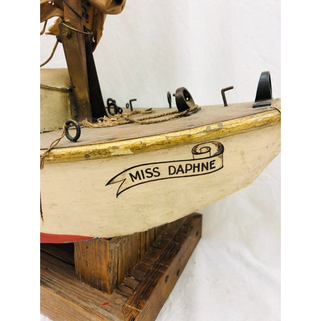 Stunning Antique Hand Painted Mechanical Model Sailboat / Ship. Named “Miss Daphne”. Fitted with custom made wooden base /...