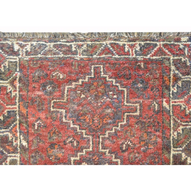 A beautiful vintage Shiraz rug with three diamond-form medallions against a field of stylized flowers and surrounded by a...