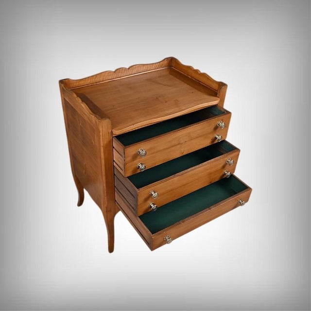 A beautiful solid walnut sideboard distinguished by its warm and refined presence, its gently curved silhouette softening...
