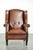 This luxurious sheepskin wingback chair is beautifully finished with black piping and decorative studs. The lining under...