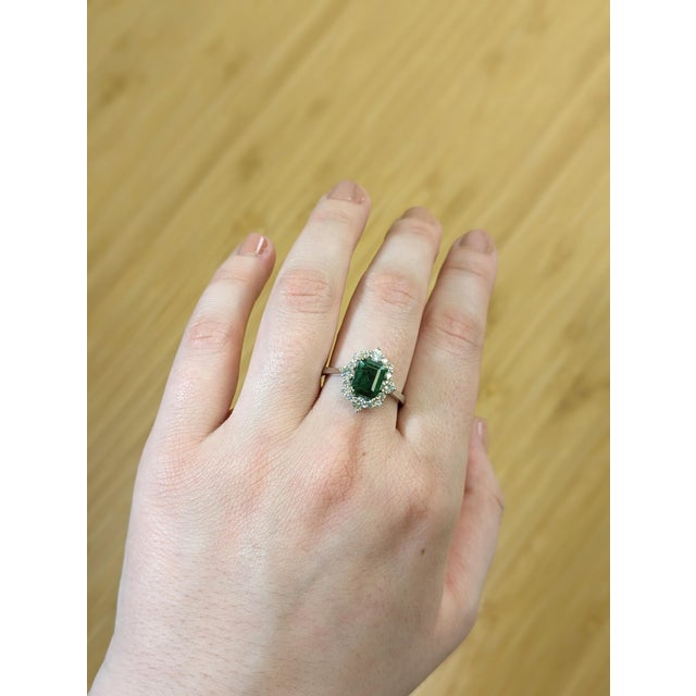 This refined statement ring features a vivid 1.5 carat Zambian emerald, emerald-cut to showcase its natural depth and...