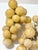 Pair of decorative stone grape clusters in warm yellow and cream tones with green stems. Display together in a shallow...