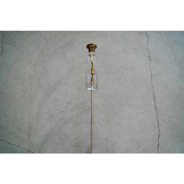 Vintage 1960's Mid century Modern sconce for sale. Made of solid brass and solid thick lucite with a lucite wall plate and...
