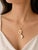 This modern 14K yellow gold necklace features a white agate key pendant slide, offering a stylish and symbolic design. A...