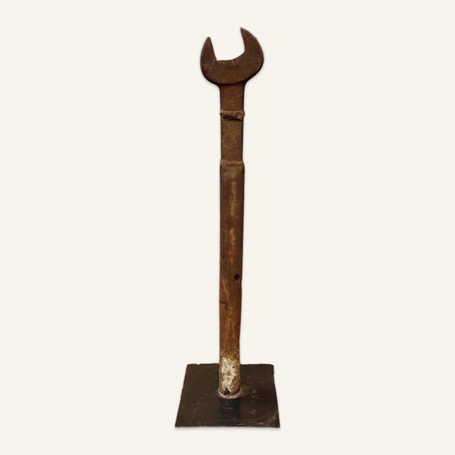 Very large industrial wrench mounted as a decorative object. In good original condition with wear consistent with age and...