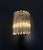 An elegant and highly decorative set of four Venini Italian Murano glass and brass wall sconces, executed in the refined...