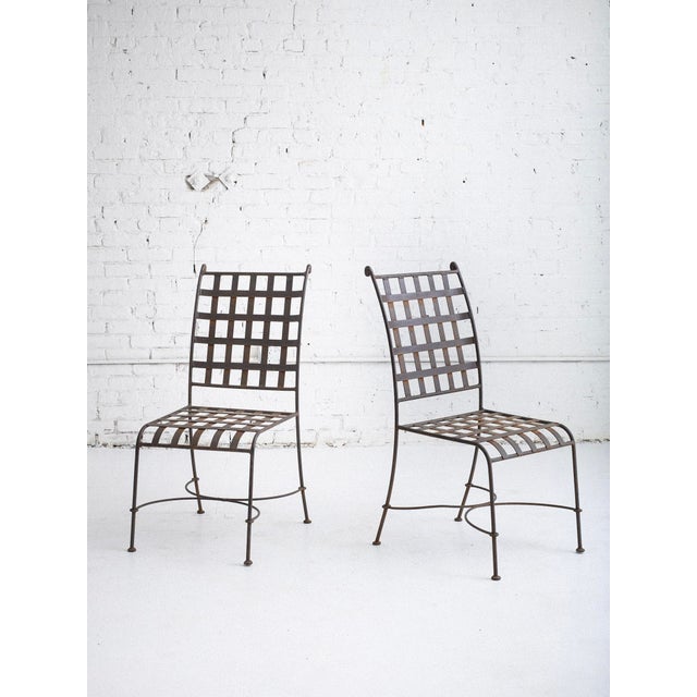 Set of five Florentine style wrought iron garden chairs. Classic silhouette with woven iron seats and backs.