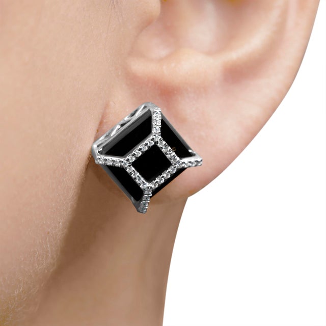 Immerse yourself in the timeless elegance of these stud earrings, where deep, color-enhanced black onyx meets the...