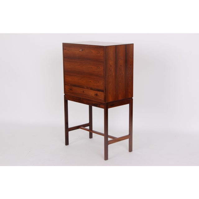 Beautiful Danish bar cabinet made of dark wood with a drawer and adjustable glass shelf. The piece is in very good...