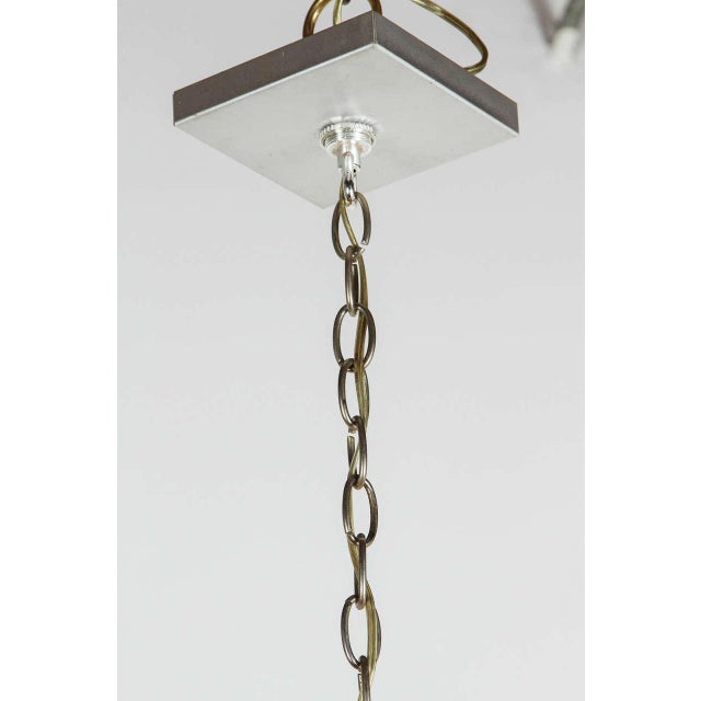 Brushed aluminum six-arm chandelier in the style of Kalmar with up and down lighting.