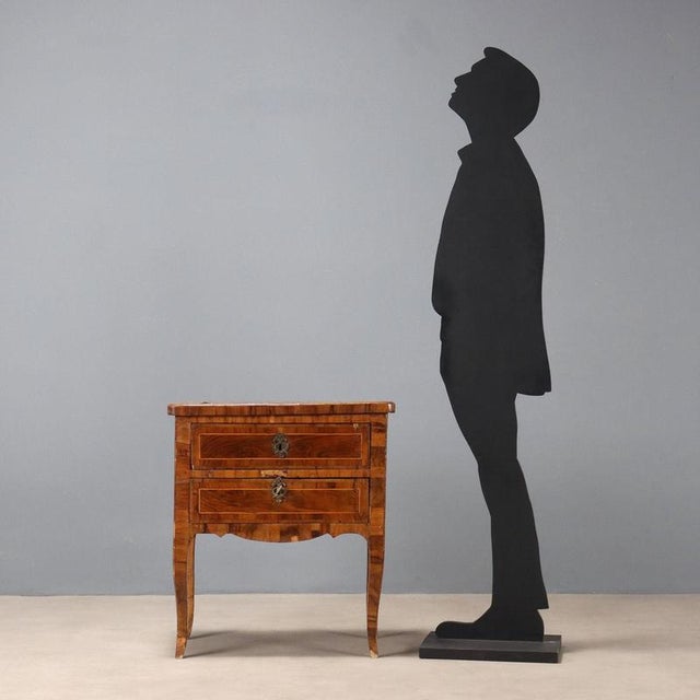 Late Baroque bedside table with walnut and olive veneer and maple trim. Two drawers with worked bronze handles, not...