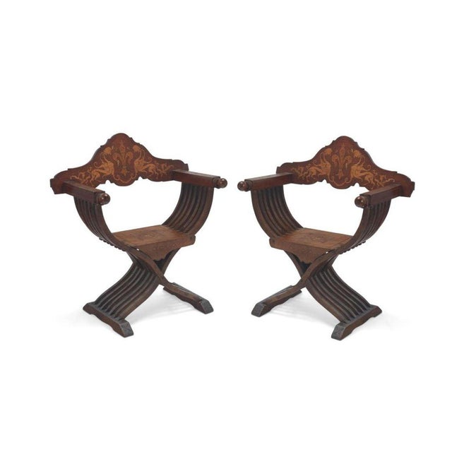 This pair of Renaissance-style Savonarola chairs, crafted from richly carved walnut, embodies the opulence and grandeur of...