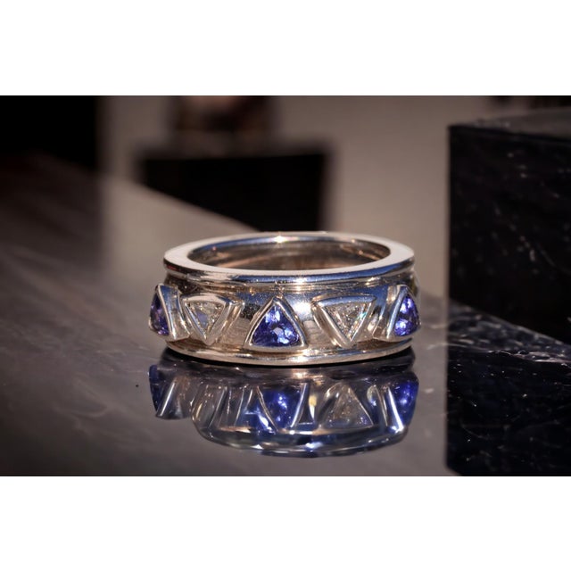 The Salinas River: Contemporary Tanzanite and Natural Diamond Ring. This captivating ring showcases a mesmerizing array of...
