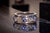 The Salinas River: Contemporary Tanzanite and Natural Diamond Ring. This captivating ring showcases a mesmerizing array of...